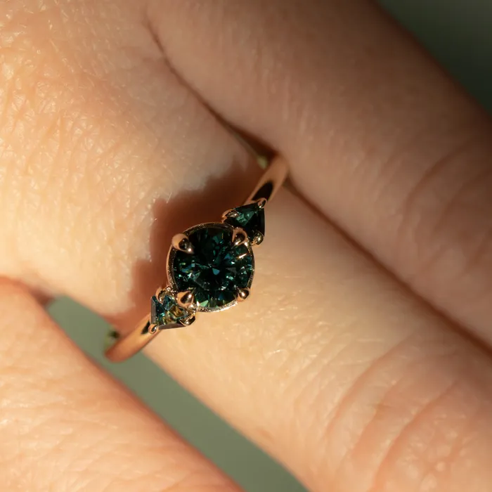 Anueva Jewelry Rings 098ct Songean Deep Teal Green Sapphire and Trillion Parti Sapphire Low Profile Ring in 14k Yellow Gold